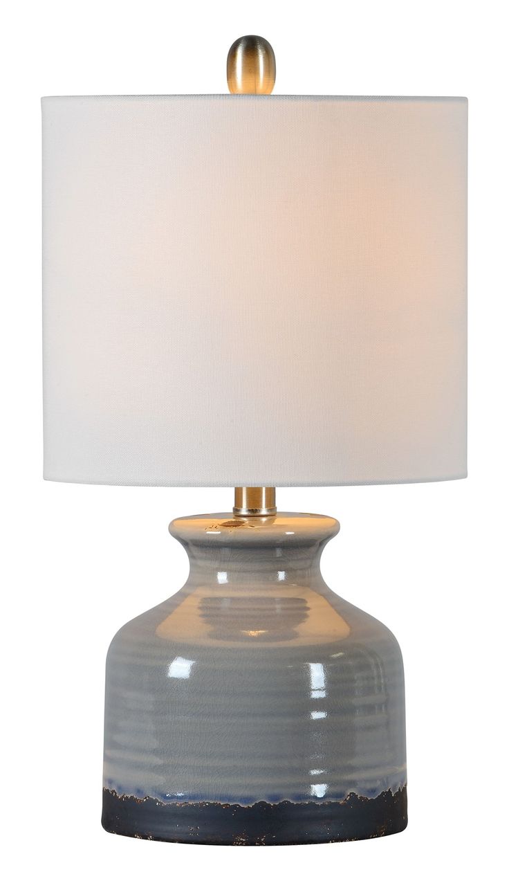 a table lamp with a white shade on it