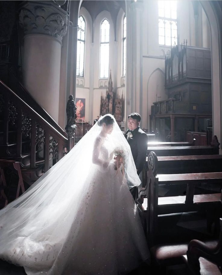 the bride and groom are sitting on the pews