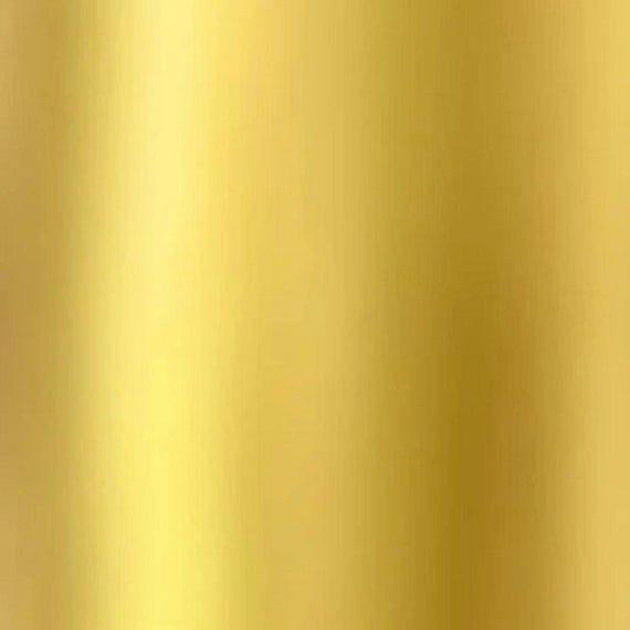 a close up view of a gold colored background