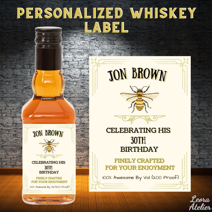 a bottle of personalized whiskey label with a bee on it and a business card