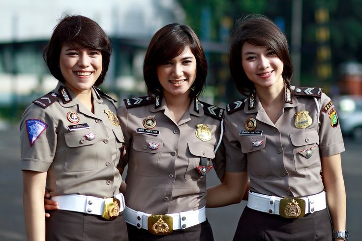 three women in uniform are posing for the camera