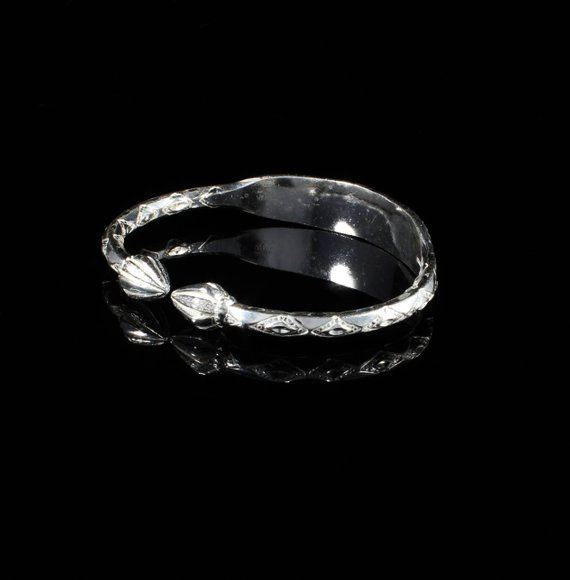 Material: .925 Sterling SilverThickness: .180" -------->About this bangle<---------This is a unique combination of the traditional West Indian Bangle with an Identification plate. The silver wire is marked with the pattern and then the plate is hammered from the middle and shaped by hand. This is a unique feature because the plate is never separate from the bangle and is less likely to break apart than some other bangles that have their plates soldered on. It does take more time and work t Sterling Silver Stackable Bangle For Anniversary, Adjustable Etched Sterling Silver Bracelet For Anniversary, Silver Toe Ring With Polished Finish, Silver Polished Toe Ring, Adjustable Engraved White Gold Bangle, Sterling Silver Oyster Bracelet For Anniversary, Unique Engraved Bangle, Silver Engraved Bangle For Anniversary, Sterling Silver Engraved Bangle For Anniversary