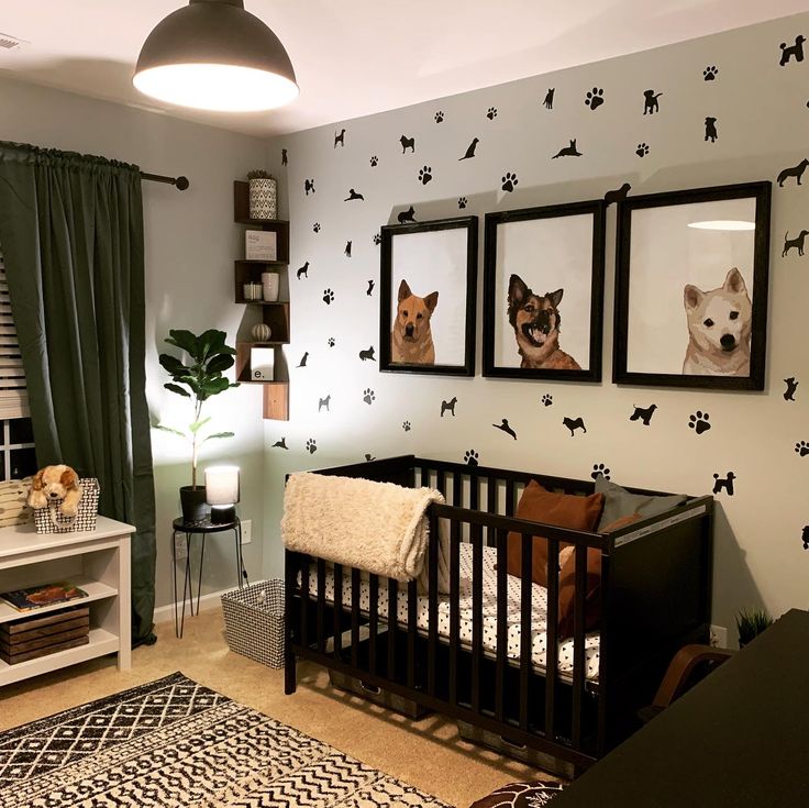 a baby's room decorated in black and white with pictures on the wall, including dogs