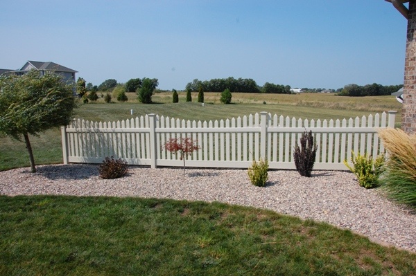 a white picket fence in front of a house