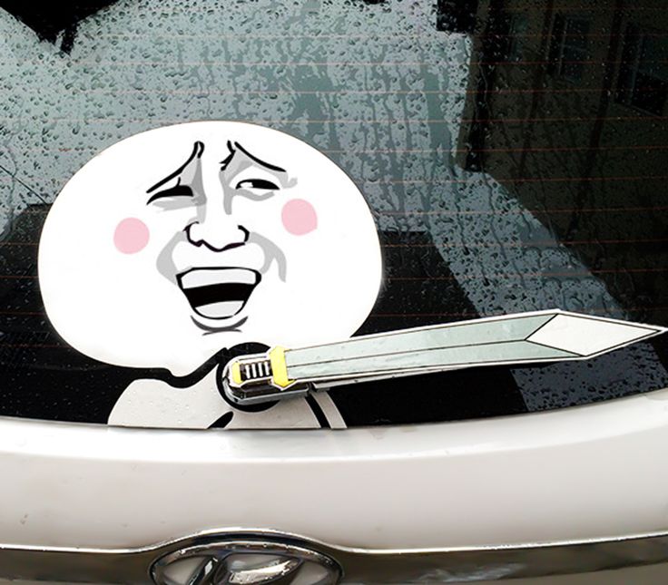 a car with a sticker on it that has an image of a man holding a knife in his mouth