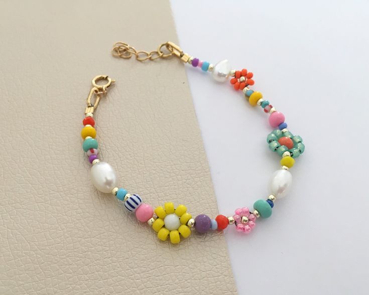 "Colourful beaded daisy bracelet/pearl and beads bracelet/pearl and seedbeds bracelet/colourful beads and pearls/Beaded flower This chic and colourful bracelet will add a little extra to your everyday style. Stack it up with your favorite bracelets or wear it alone for a clean style. SPESIFICATIONS: Materials: * Real freshwater pearls. * A colourmix of seedbeads, gemstones and glass beads. Beaded daisy flowers in different sizes makes cute details. * Goldfilled clasp. Size: Lenght: Adjustable wi Colorful Bohemian Beaded Bracelets For Spring, Bohemian Handmade Multicolor Pearl Bracelet, Handmade Bohemian Pearl Bracelet For Summer, Handmade Multicolor Bohemian Pearl Bracelet, Handmade Pearl Bracelet For Summer Gifts, Handmade Pearl Bracelet Summer Gift, Handmade Pearl Bracelet With Round Beads For Summer, Spring Gift Pearl Bracelet With Round Beads, Dainty Multicolor Summer Bracelet