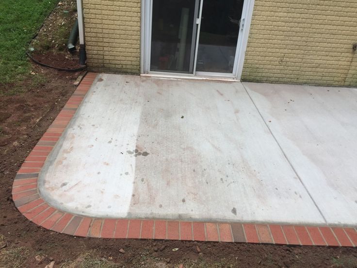 the patio is being laid out with bricks and cement on it's side walk