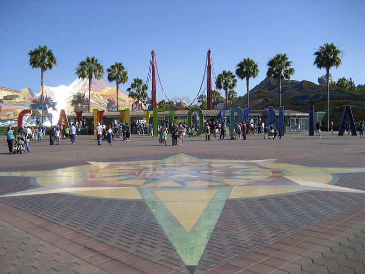 people are walking around an amusement park