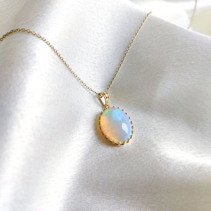 This stunning Pendant is set in 14k Solid Yellow Gold with Natural Ethiopion Opal with utmost precision. It is a unique gemstone Pendant for nearly every occasion and is completely hassle-free jewelry. ITEM DETAILS: * GEM: Ethiopion Opal * GEM SIZE: 12x16mm * GEM SHAPE: Oval * Gem weight: 6.39 carats * Gold Purity: 14KT (58.33% approx.) * Gold Weight: 1.16 gram * Total Weight of the Pendant: 2.44 gram The Gold purity is guaranteed and it comes with authentic 14KT gold hallmark. Since my items are handmade, they are absolutely nickel and lead free. CUSTOMIZATION: * Gemstone customization is available and it can be substituted with a gem of your choice. Kindly message me for the same. PACKAGING * The Pendant comes with layers of safe and secure wrapping along with Free handmade jewelry box w Elegant Ethiopian Opal Pendant Necklace, Elegant Ethiopian Opal Cabochon Necklaces, Elegant Ethiopian Opal Gemstone Necklaces, 14k Gold Birthstone Jewelry For Celebration, Elegant Ethiopian Opal Necklace In Gold, Yellow Gold Ethiopian Opal Round Necklace, Yellow Gold Ethiopian Opal Necklace, Elegant Ethiopian Opal Jewelry With Cabochon, Elegant Ethiopian Opal Oval Pendant Necklace