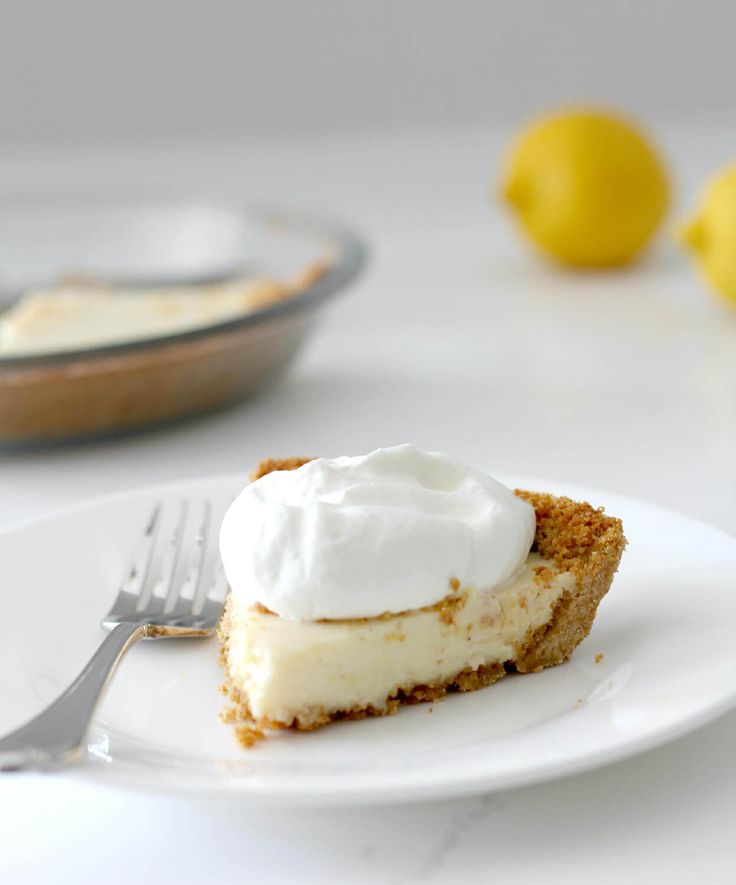 a slice of lemon pie on a plate with a fork