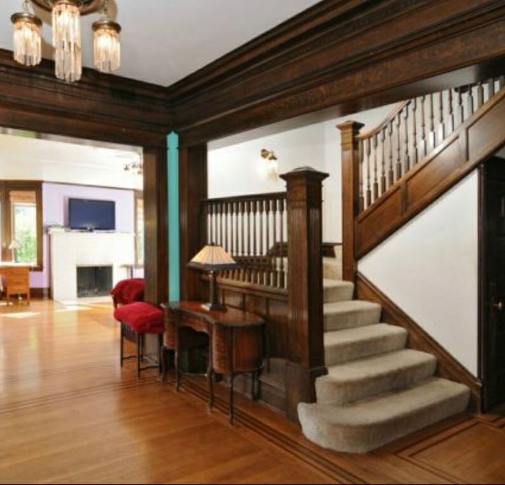 a living room filled with furniture and a stair case