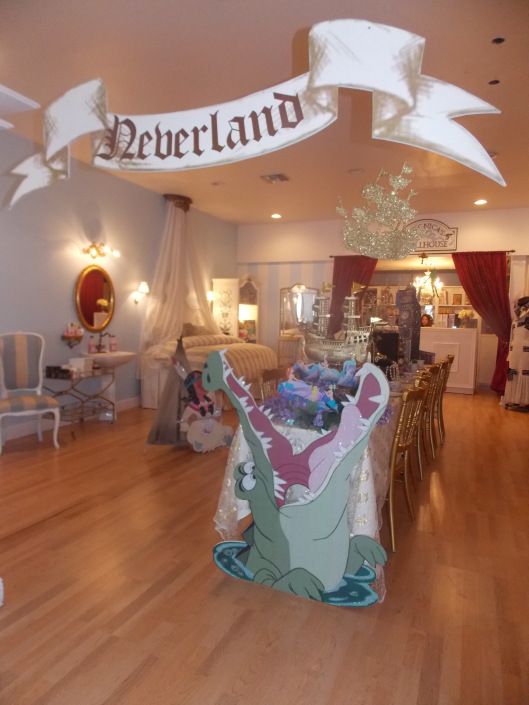 there is a room with many items on the floor and decorations hanging from the ceiling