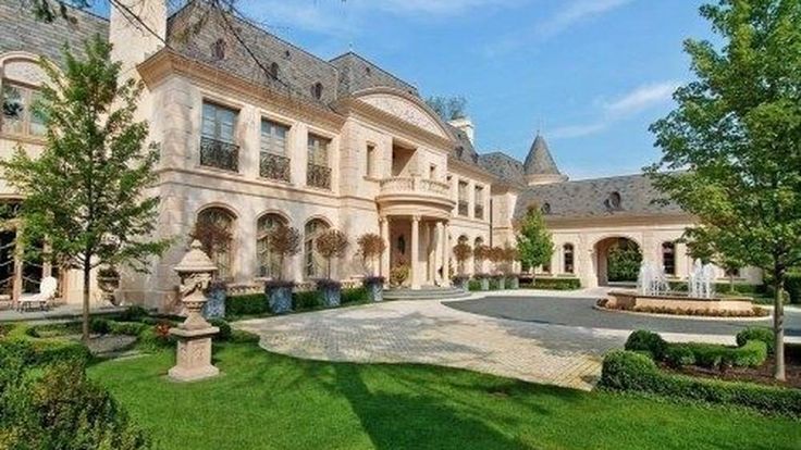 a large house with lots of windows and landscaping