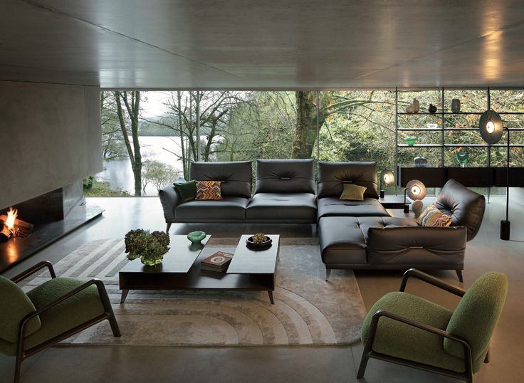 a living room filled with furniture and a fire place in the middle of the room