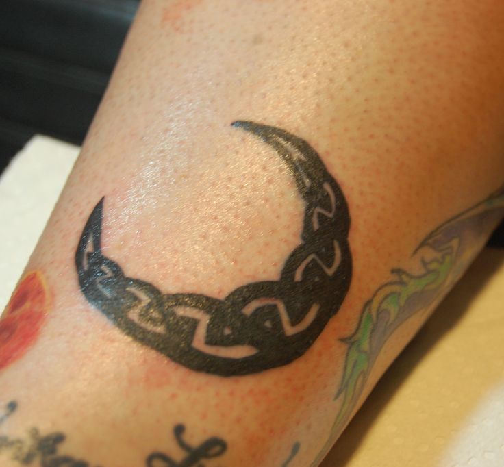 a close up of a person's leg with a tattoo on it