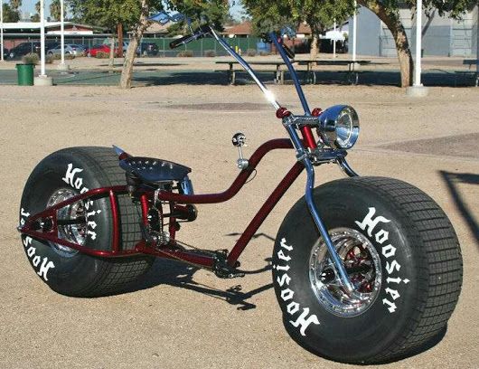 an unusual looking motorcycle is parked in the parking lot with its wheels and tire rims