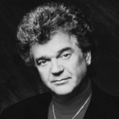 a black and white photo of a man with curly hair