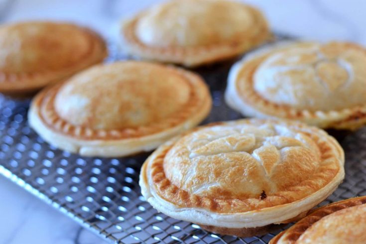 several small pies on a cooling rack ready to be baked in the oven or used as an appetizer