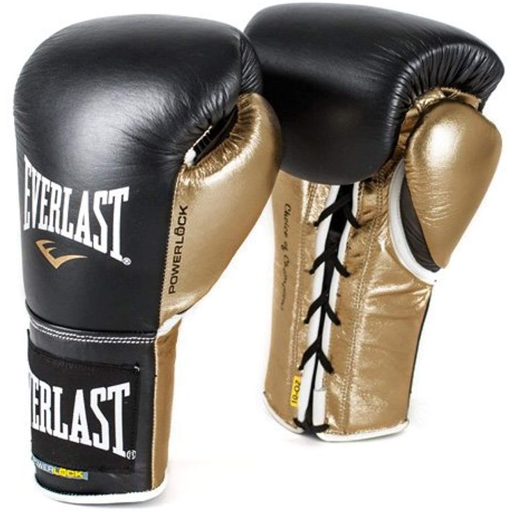 two black and gold boxing gloves sitting on top of each other