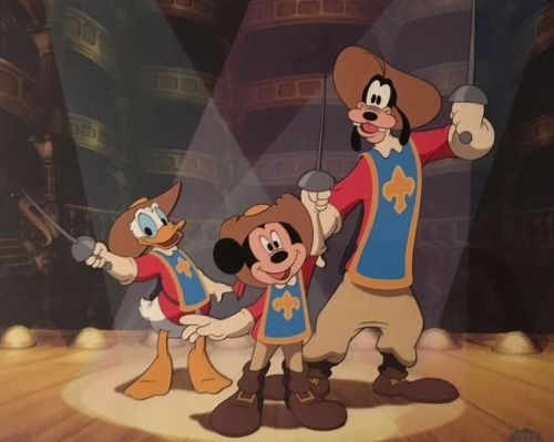 mickey mouse and friends on stage in front of spotlights