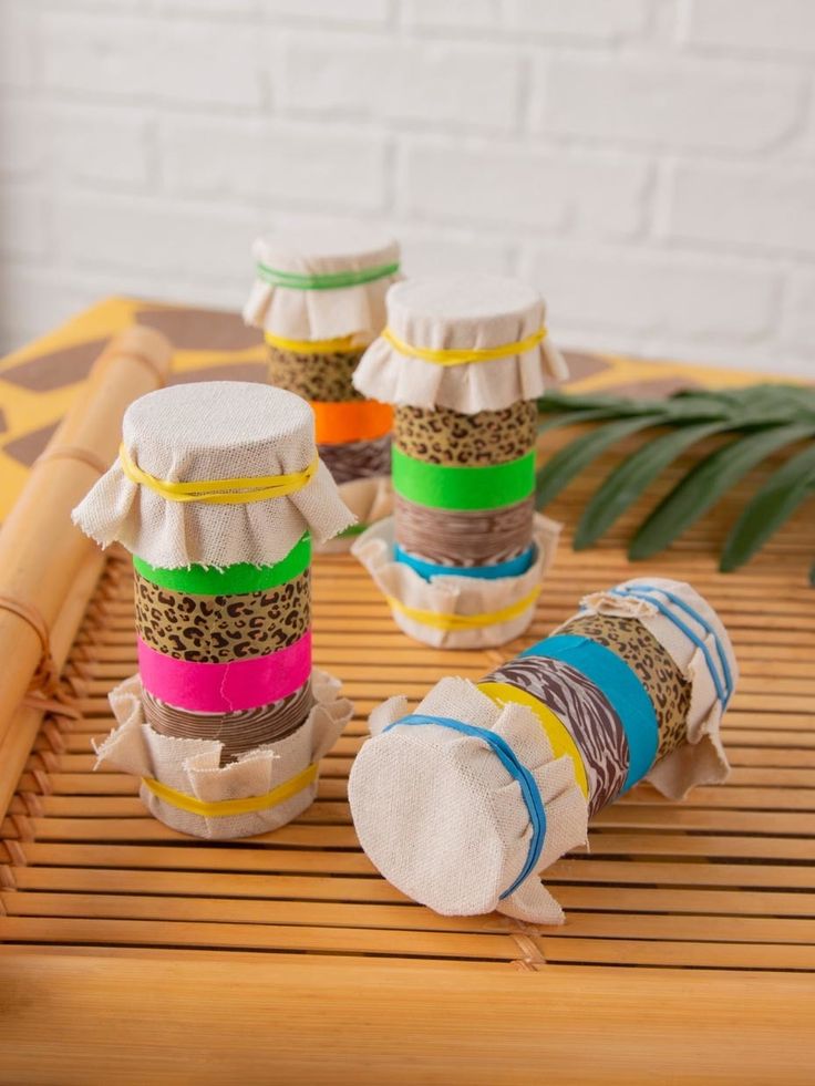 several rolls of fabric sitting on top of a bamboo mat