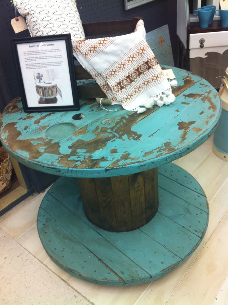 an old table has been turned into a unique coffee table for sale at the store