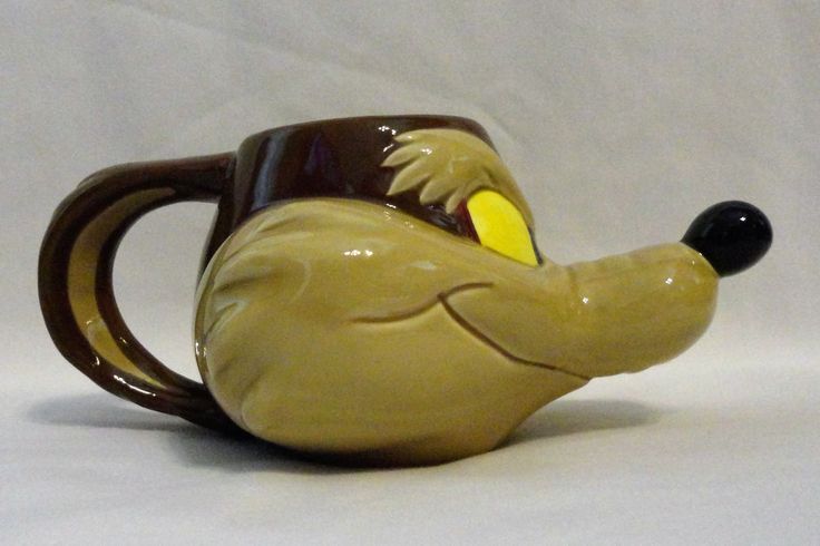 a ceramic coffee mug with a goofy face on it