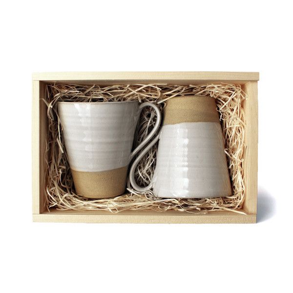 two coffee mugs in a wooden box