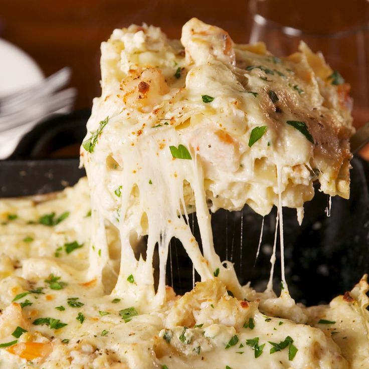 a spatula scooping out some food from a casserole dish on a plate