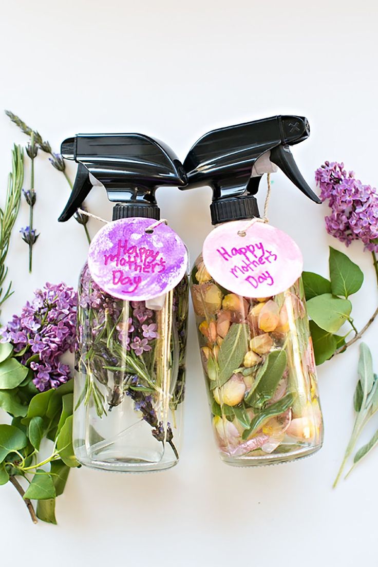 two bottles filled with flowers and plants next to each other