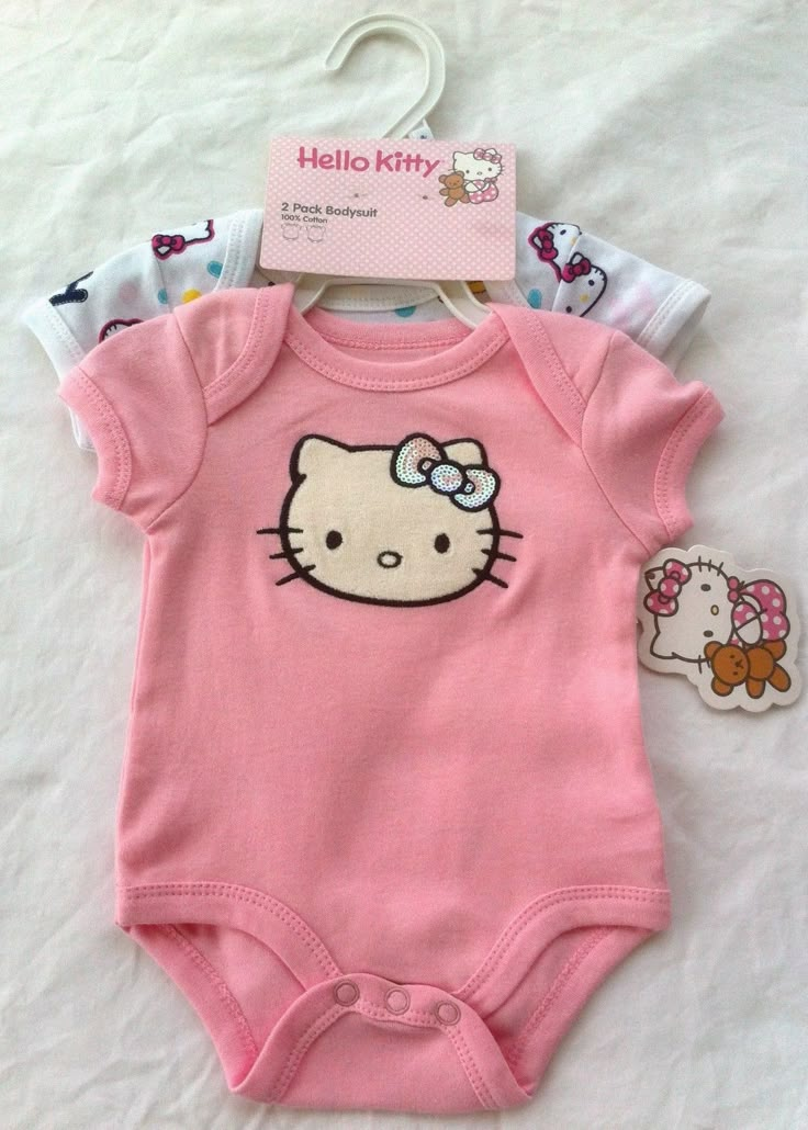 a pink hello kitty bodysuit with an image of a cat on the front and back