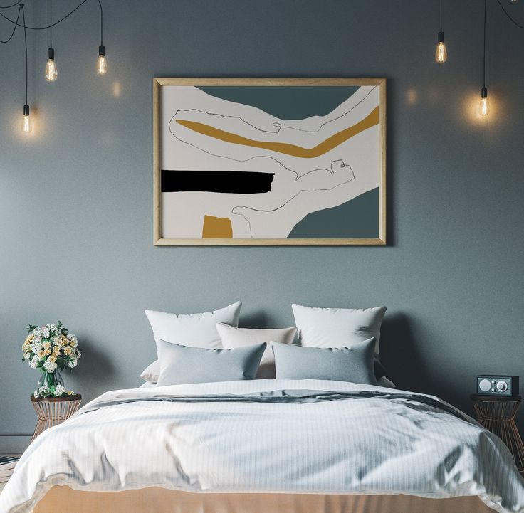 a bed with white sheets and pillows in front of a framed painting on the wall