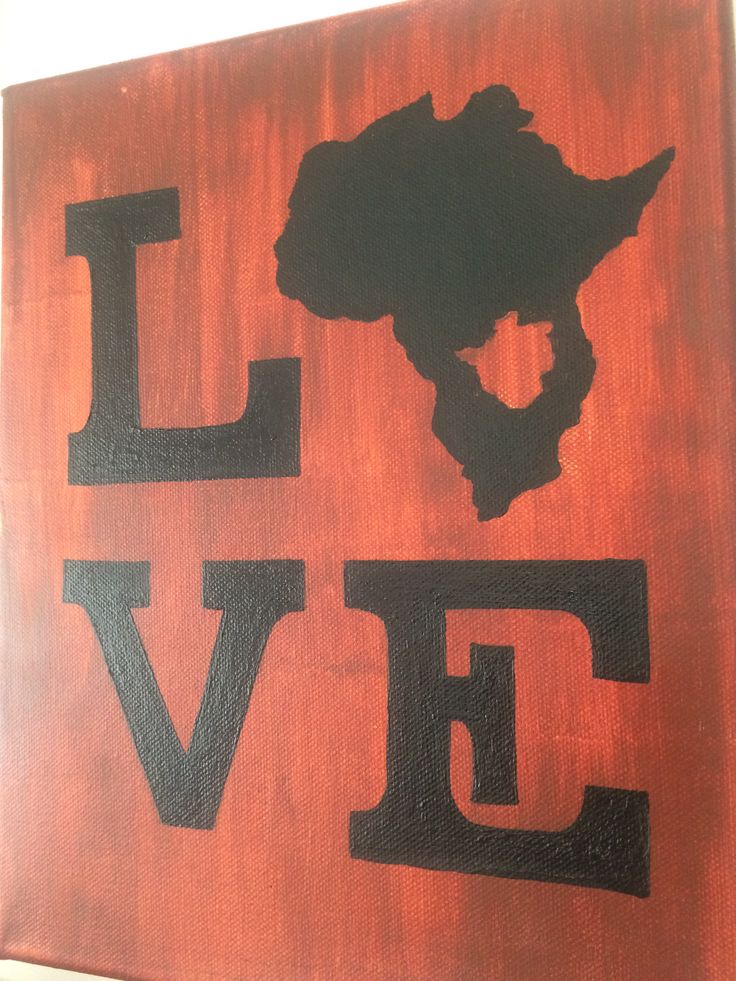 a wooden sign with the word love in black and red painted on it's side