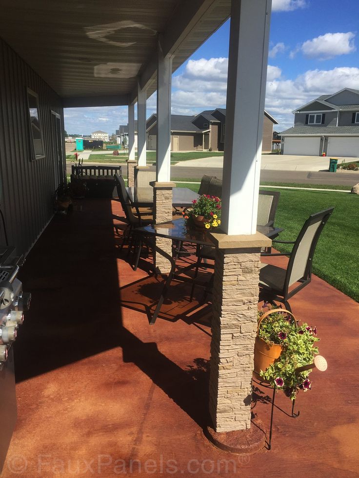 an outdoor covered patio with chairs and tables