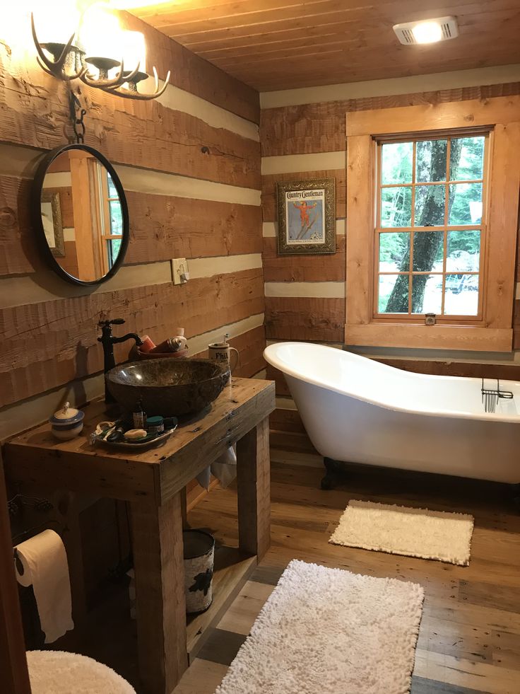 a bathroom with wood paneling and a white bathtub next to a wooden sink