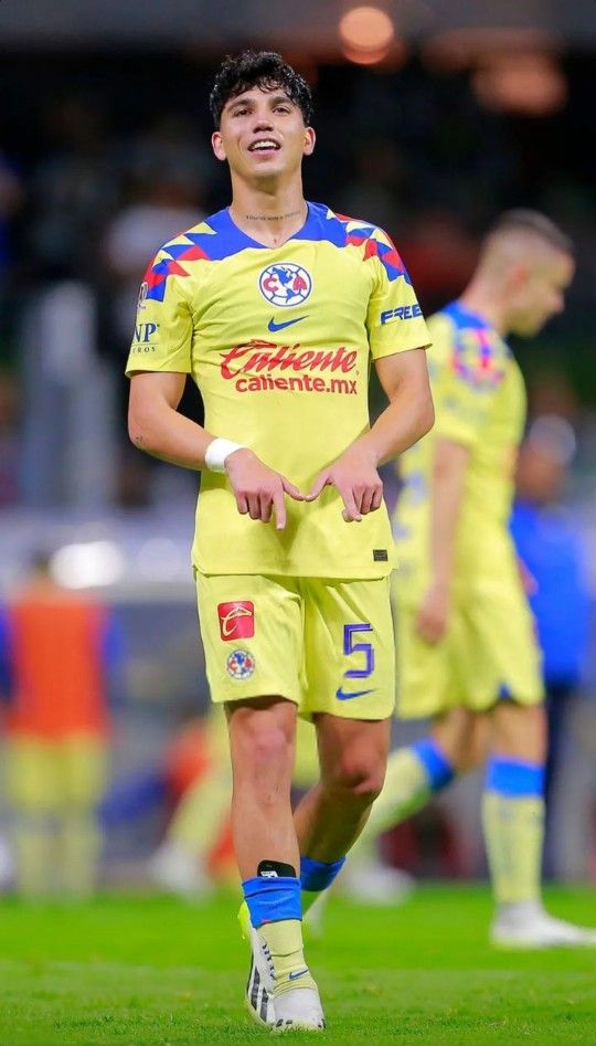 a soccer player is walking on the field