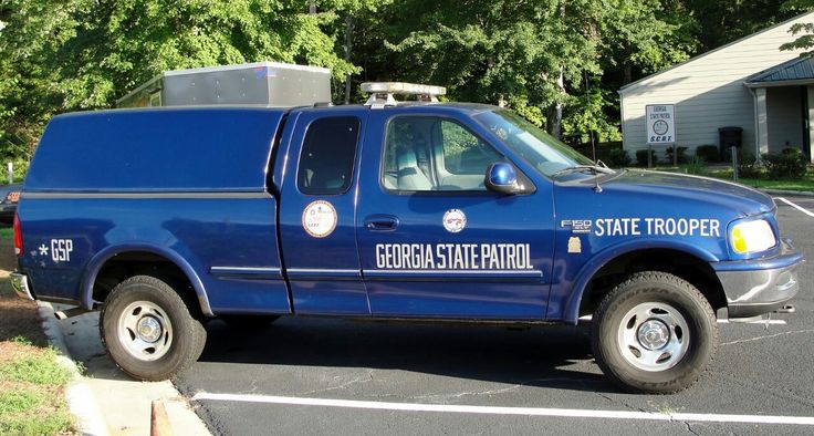 a blue state trooper truck parked in a parking lot