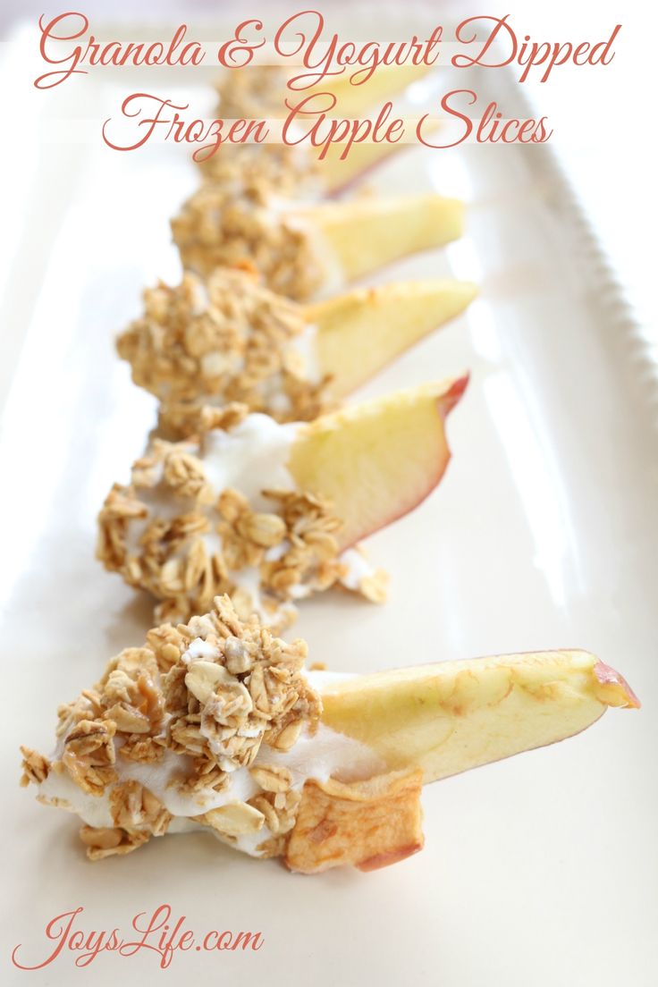 granola and yogurt dipped fresh apple slices on a white plate with text overlay