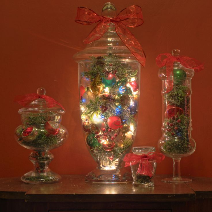 an assortment of christmas decorations in glass jars