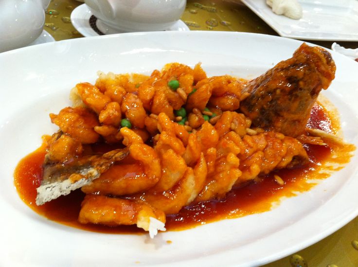 a white plate topped with meat covered in sauce