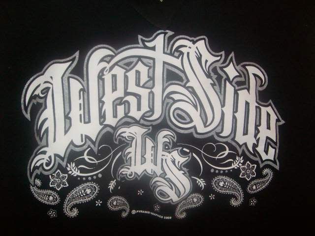 the back side of a black shirt with white lettering and paisley designs on it,