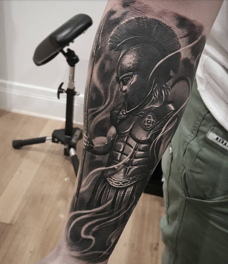 a man's arm with an elephant tattoo on the left side of his body