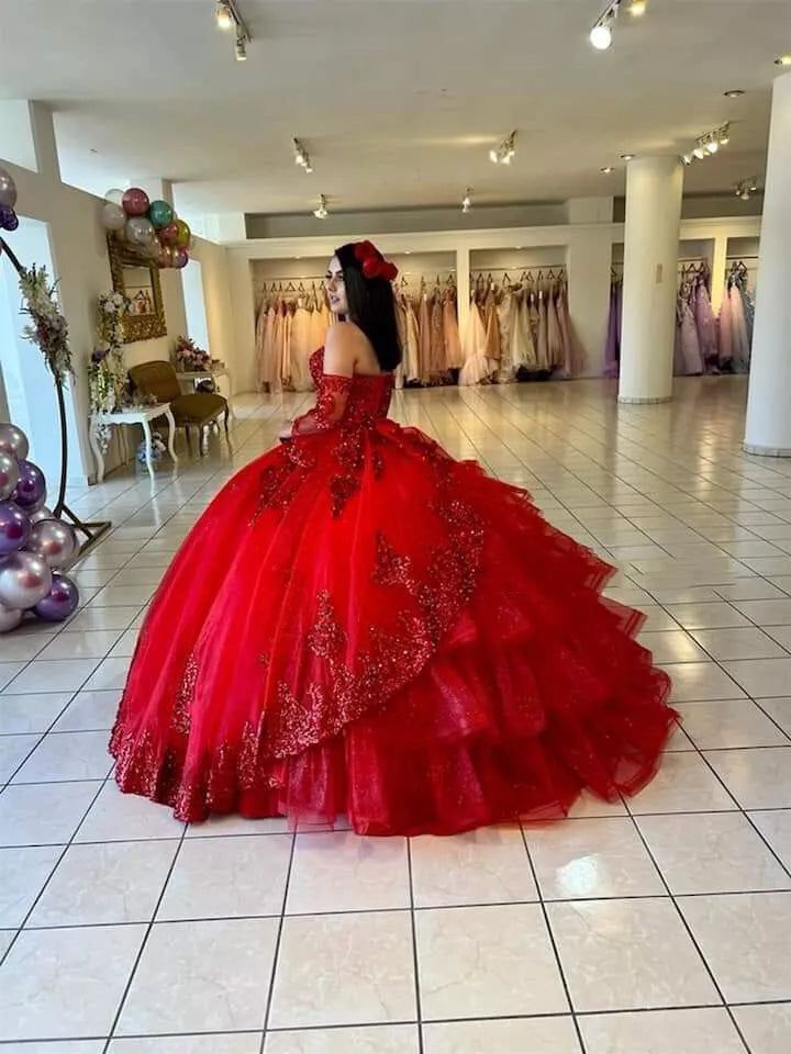 Make a grand entrance with this stunning red sweetheart quinceanera dress. This dress is crafted in luxurious lace fabric and features a dramatic chapel train that adds an element of elegance and sophistication. The long sleeves and lace-up back provide a perfect blend of tradition and modernity, while the appliqued embellishments bring intricate detailing to the forefront. Details: Silhouette: Ball-Gown Style Fabric: Lace Fabric Color: Red Color Length: Chapel-Train Neckline: Sweetheart Neckline Sleeves: Long-Sleeve Back: Lace-Up Back Embellishment: Appliqued Red Quinceanera Dresses Butterfly, Quinceanera Dresses With Long Sleeves, Red Xv Dresses, Dark Red Quinceanera Dresses, Red Quince Dress, Red Quinceanera Ideas, Puffy Prom Dresses, Quinceanera Dresses Red, Mexican Quinceanera Dresses