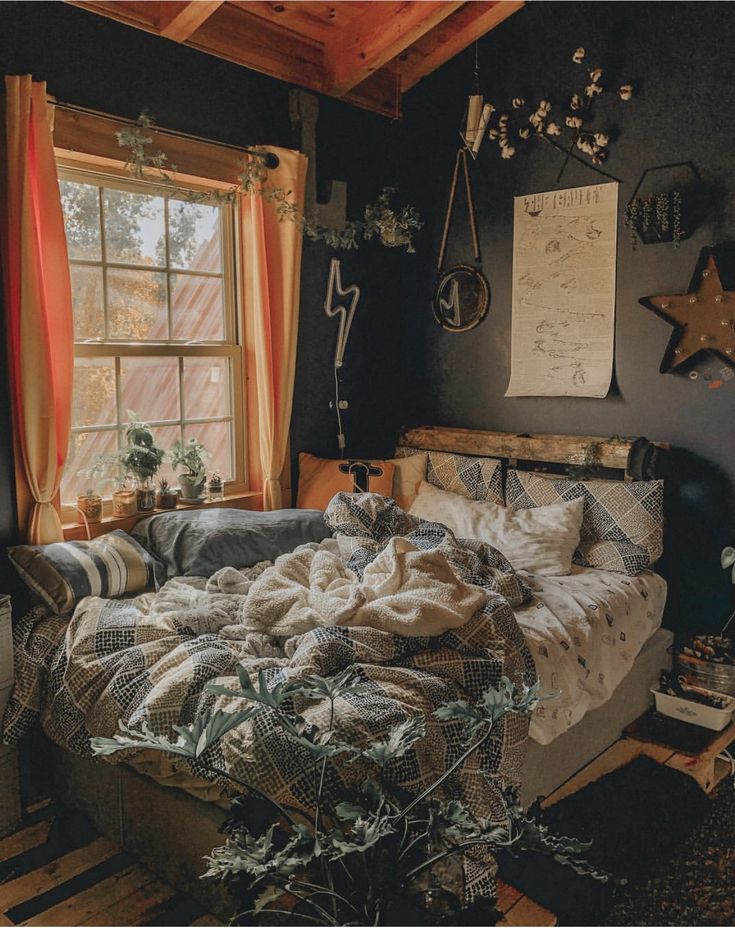 an unmade bed sitting next to a window in a bedroom