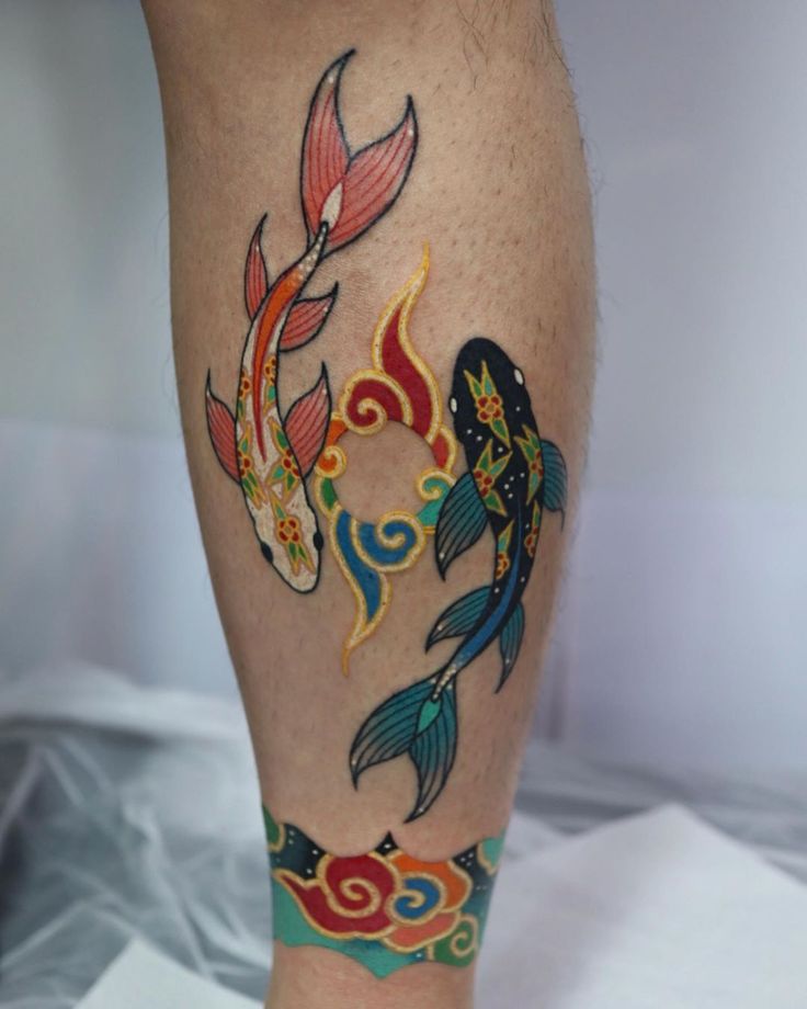 a person with tattoos on their legs and leggings that have fish in them