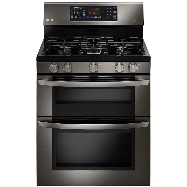 two silver ovens side by side on a white background