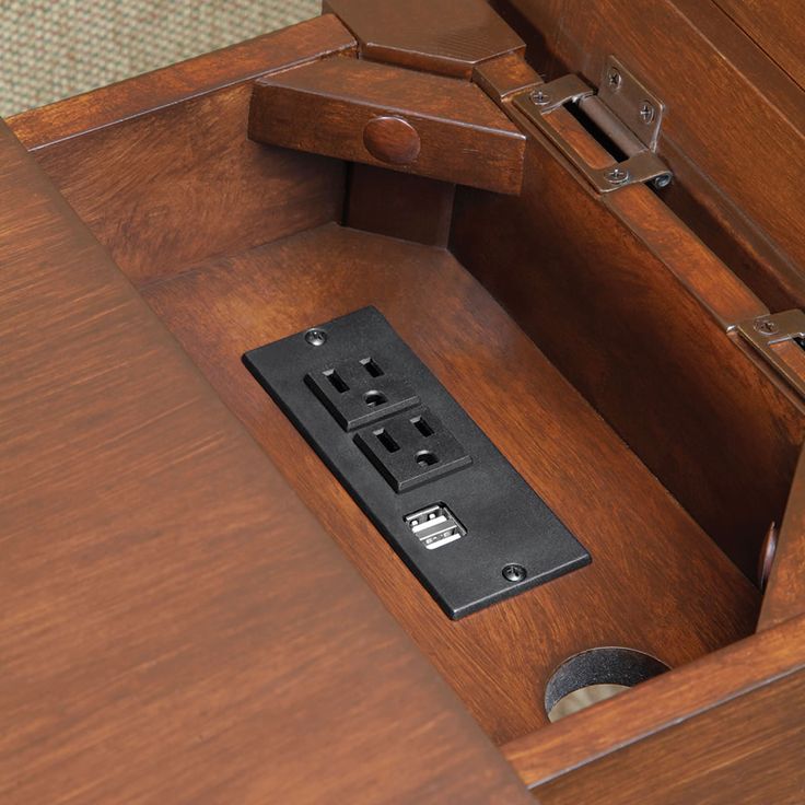 a wooden desk with a drawer open on the bottom and two metal latches at the top