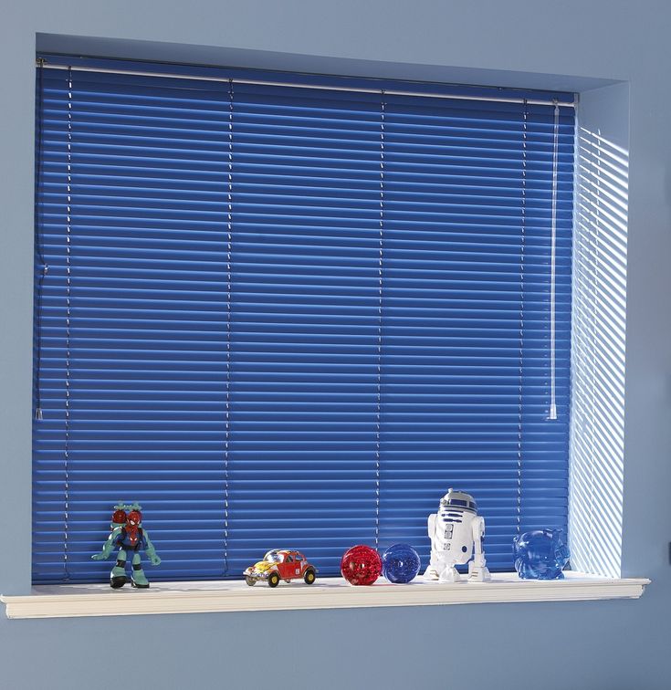 a window with blue blinds and toys on it