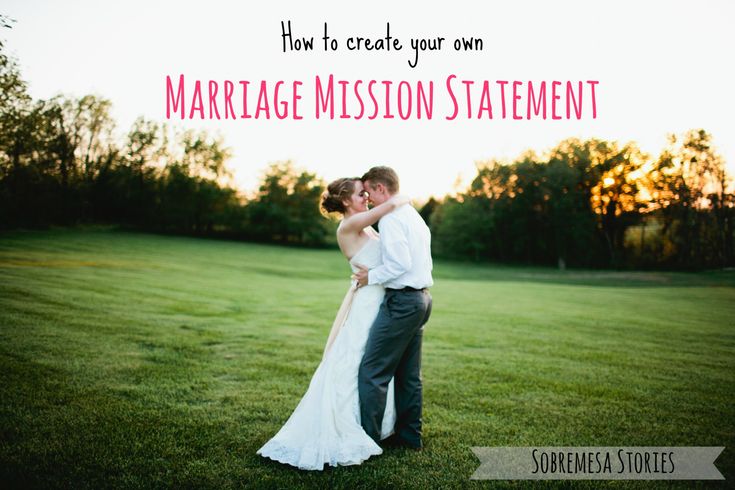 a bride and groom kissing in the middle of a grassy field with trees in the background