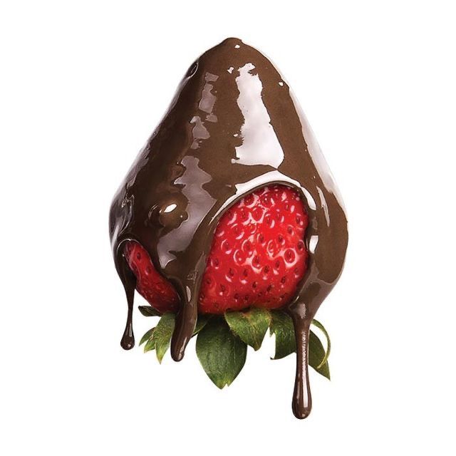 a chocolate covered strawberry is being dipped in chocolate